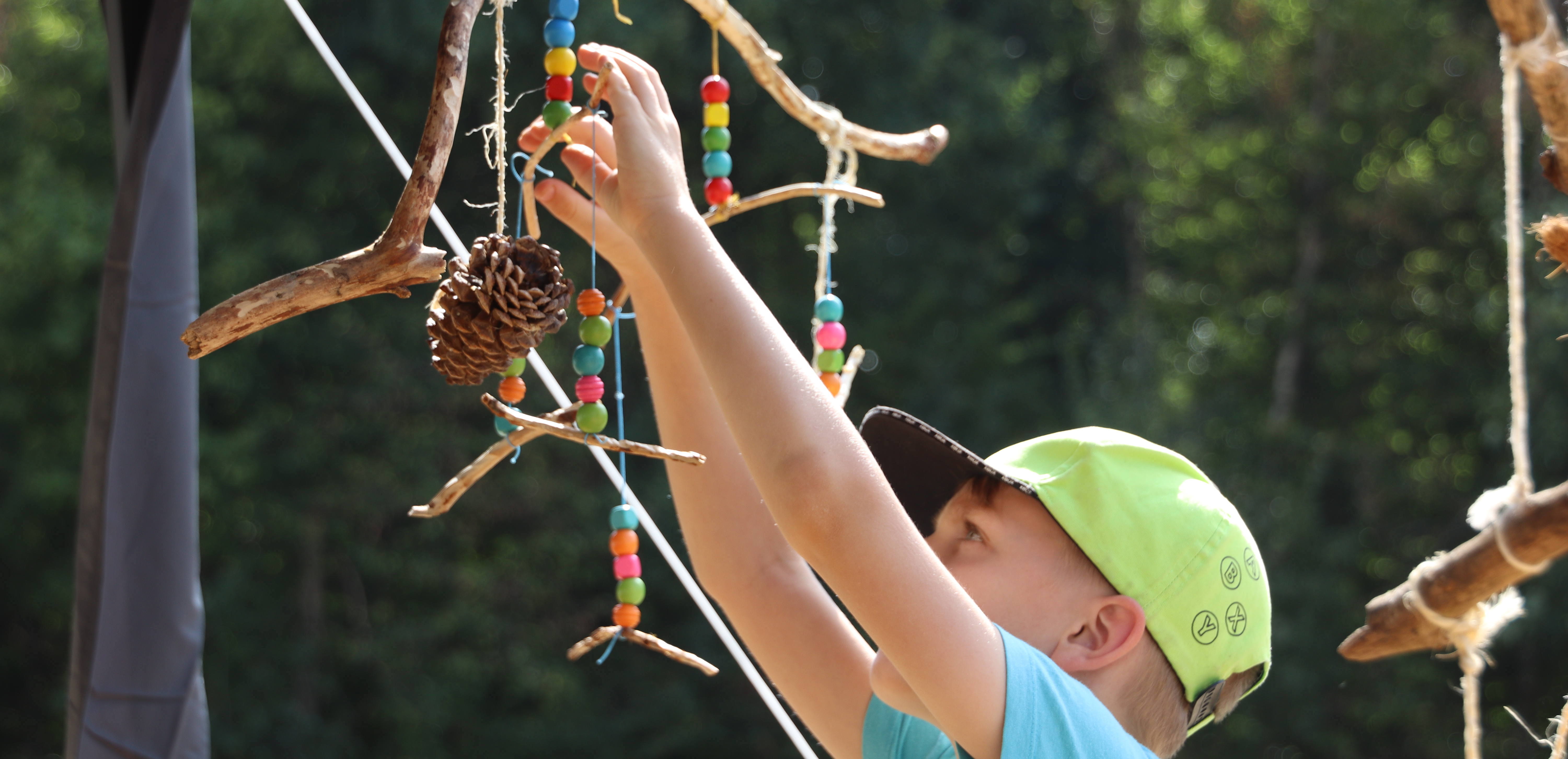 Impressionen FUNKT 2022: ein Kind arbeitet an einem selbstgebastelten Windspiel