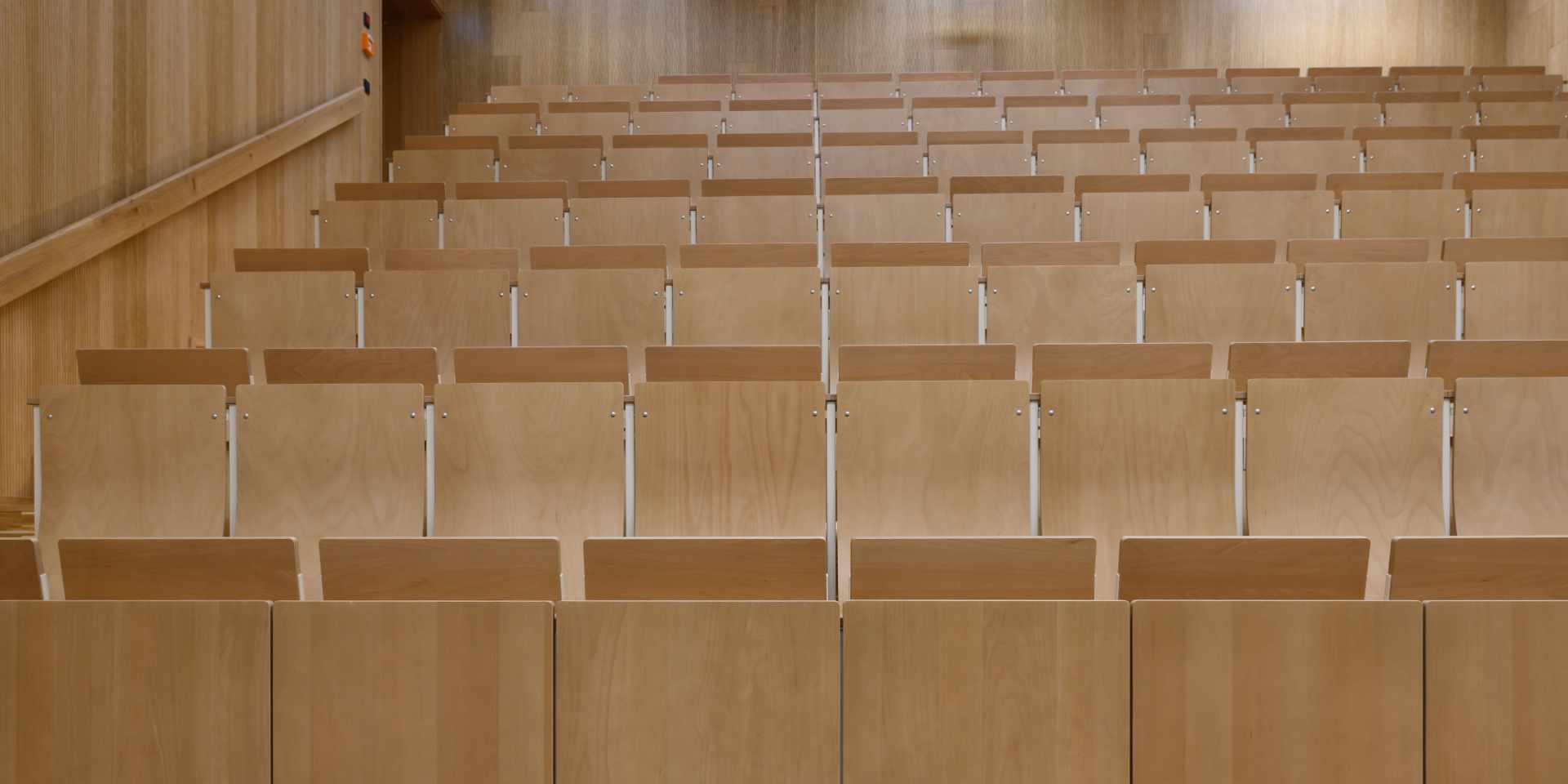 Detail einer modernen Hörsaales mit Holzverkleidungen an Wänden und Bänken